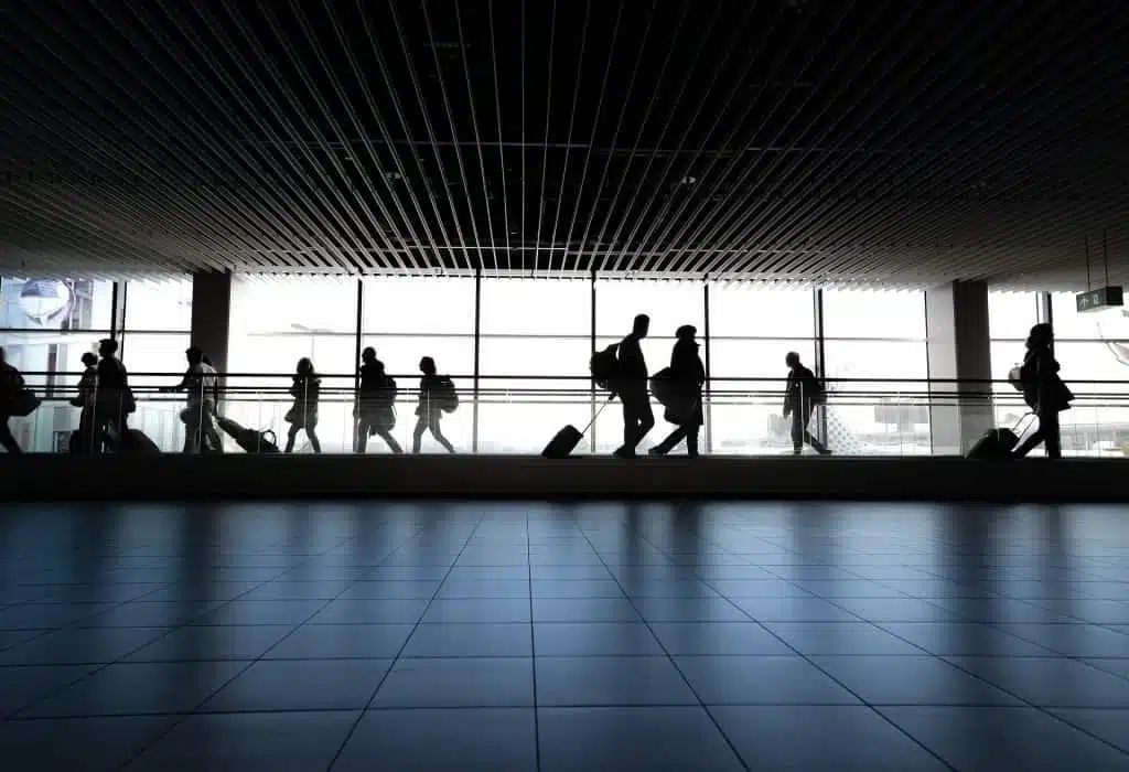Pay online 1 passengers walking through airport terminal