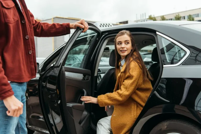 Biggleswade to Heathrow Airport £115 1 Biggleswade airport taxis driver opening door for lady passenger